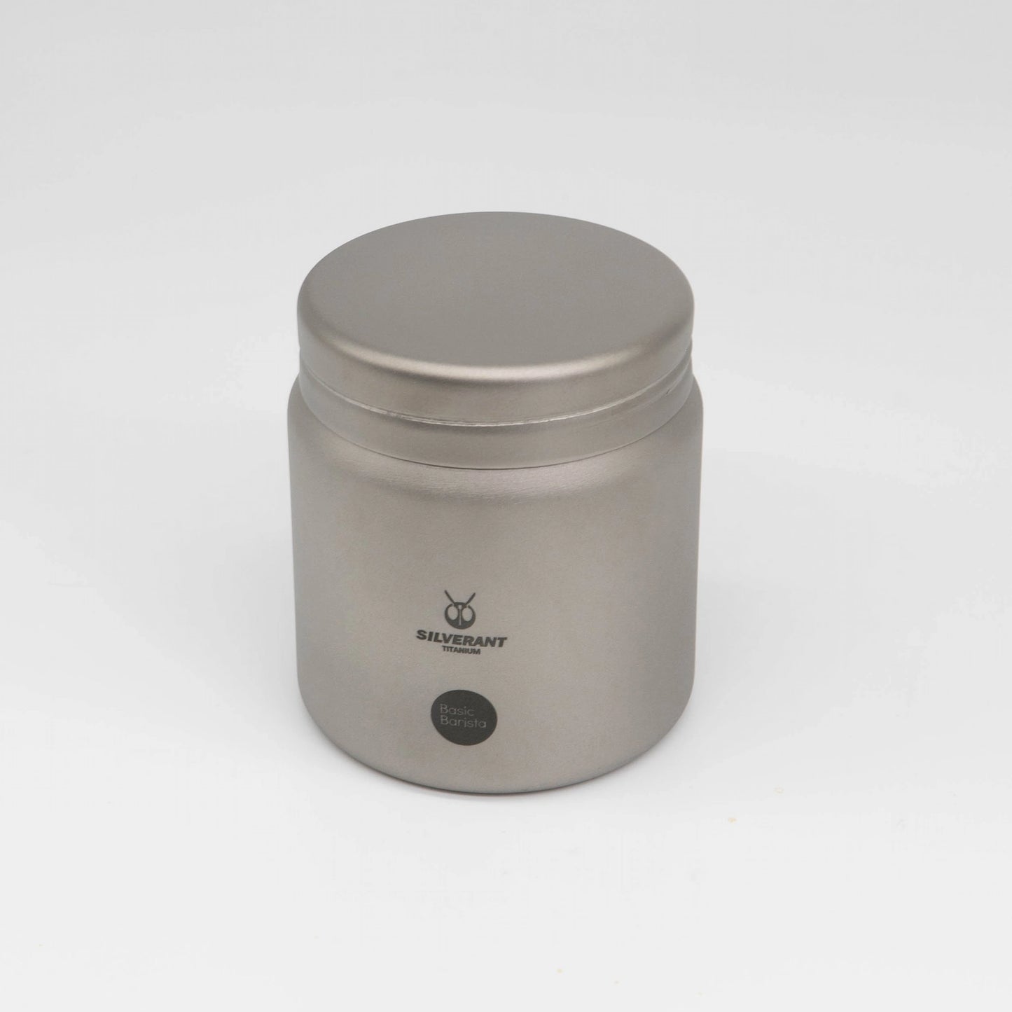 Silver titanium metal container with coffee beans on a white background Basic Barista Coffee Gear Logo Etched Coffee Bean Storage container