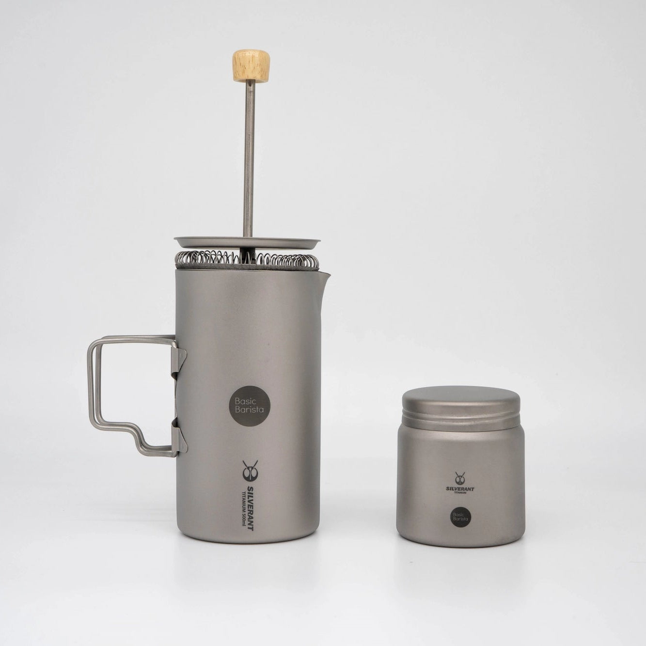 Grey Titanium coffee press with wooden handle and Basic Barista Coffee Bean Storage Container on a white background Basic Barista Coffee Gear