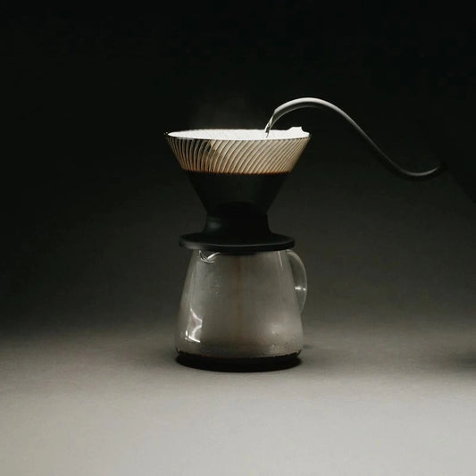 Hario V60 NEO Dripper Black Coffee Pour Over Cone Dirpper ribbed walls brewing filter coffee on black background with gooseneck kettle spout Basic Barista cinematic pour over coffee image