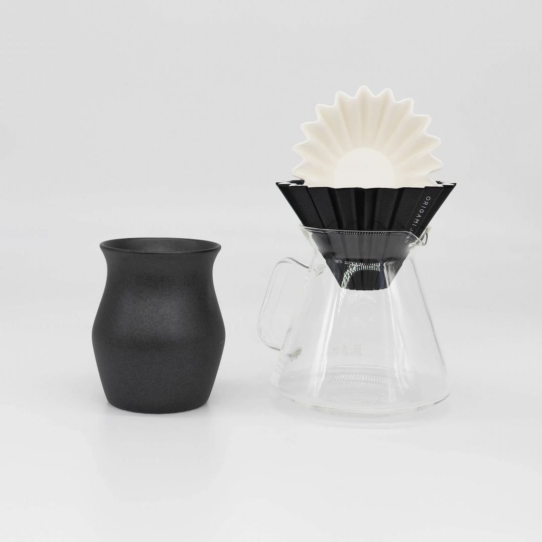 Black ceramic Origami Dripper with white paper coffee filter, clear glass Origami x Hario Server, and black ceramic coffee cup on a white background Basic Barista Coffee Gear Bundle Coffee kit