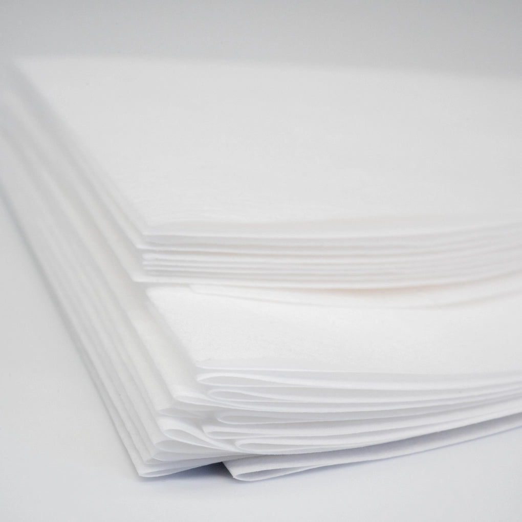 New Generation Filter Paper 100pk Perme Filter Basic Barista Permeable Filter Paper Coffee Brewing Filter Close up folded paper stacked White background