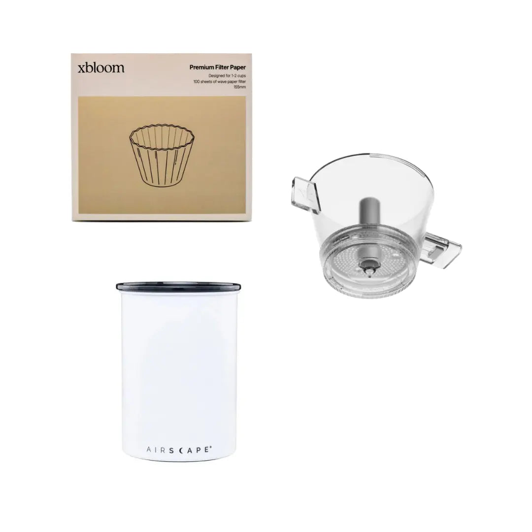 Tea-making set with filter paper, white container, and glass pitcher on a white background