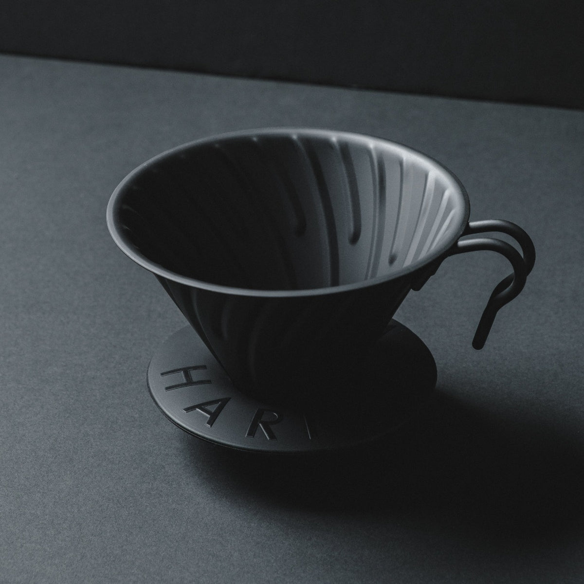 Hario V60 Metal Matte Black Coffee Dripper Basic Barista on Matte Black Background with shadowy cinematic aesthetic style