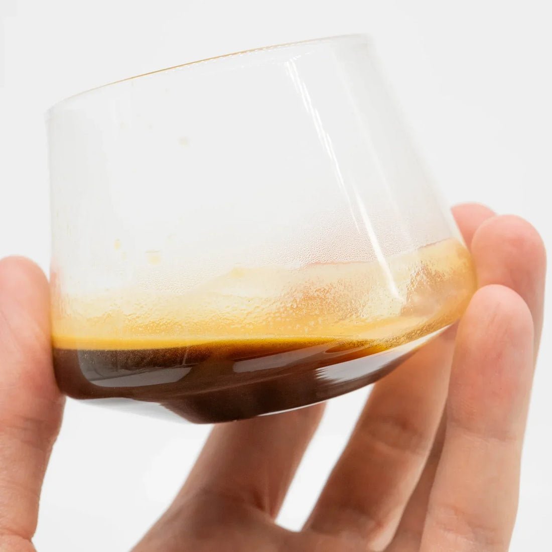 Sonic Seasoning - How Music Can Change The Taste Of Your Coffee Basic Barista Espresso in glass holding on white background 