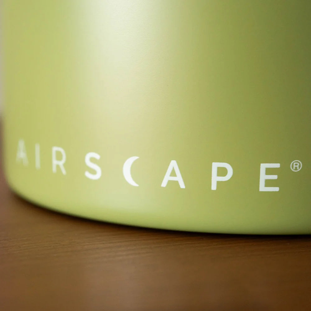 Airscape Coffee Canisters Basic Barista Green Metal Container on wood bench top 'Airscape' Logo