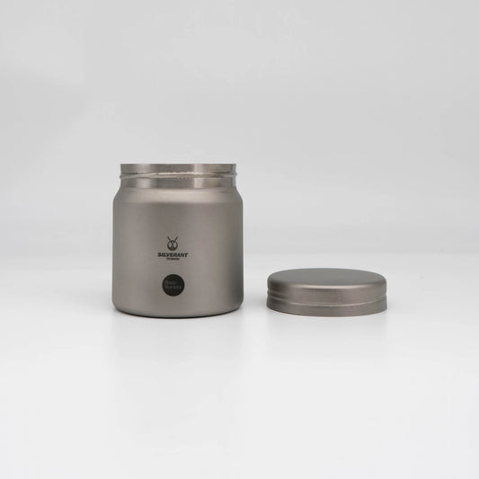 Silver titanium metal container with coffee beans on a white background Basic Barista Coffee Gear Logo Etched Coffee Bean Storage container 