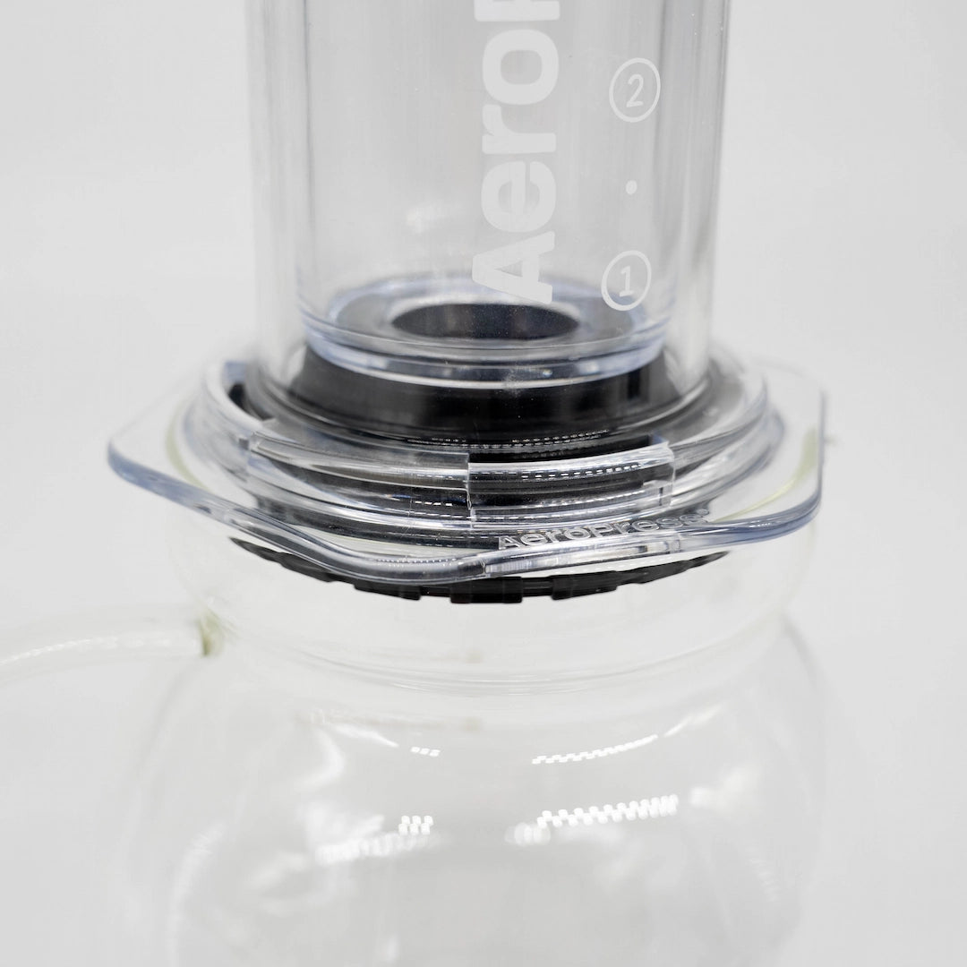 A 600ml glass coffee server carafe by Brewista, featuring a clear glass body, a black lid, and a clear glass handle, shown on a white background. AeroPress Compatible