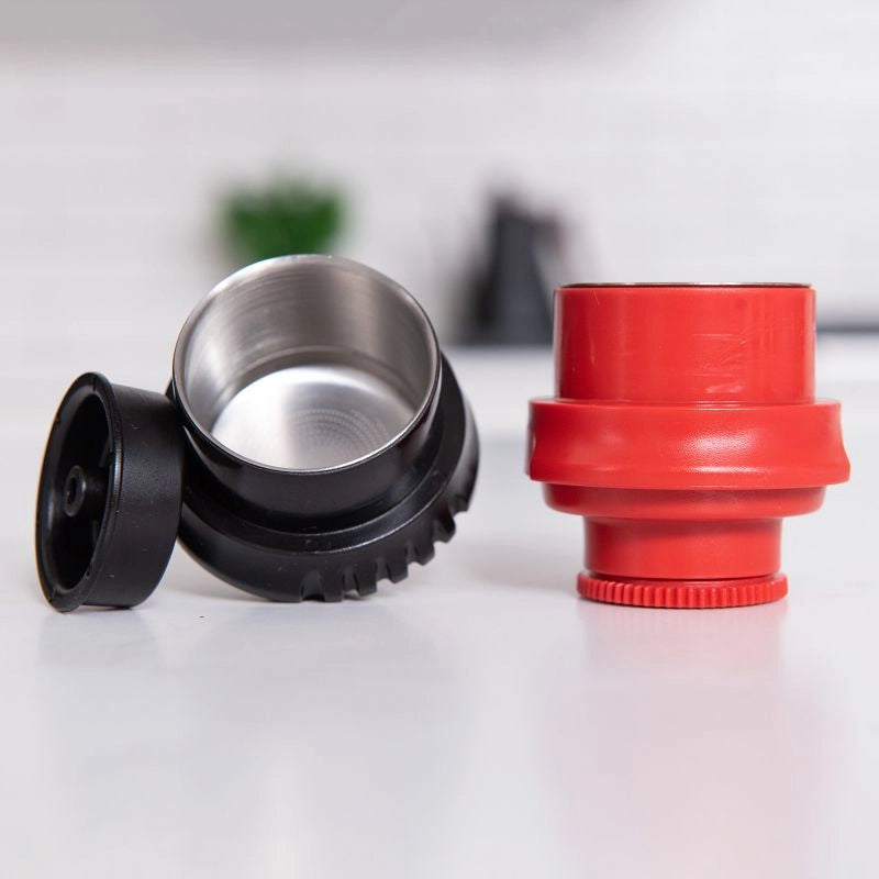 Red and black plastic espresso baskets on a white surface with a blurred background Flair Neo Flex Manual Espresso Baskets