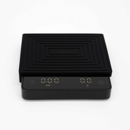 Digital scale with a black and gold heat pad on a white background Matrix G1 FlowBar Smart Pocket Coffee Scale Basic Barista Coffee Gear