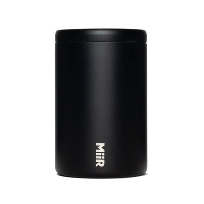 A matte black cylindrical insulated container with a matching lid, featuring the vertical white 'Miir' logo near the bottom, set against a plain white background.
Miir Airlock Coffee Storage Container