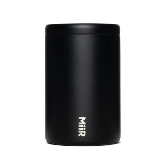 A matte black cylindrical insulated container with a matching lid, featuring the vertical white 'Miir' logo near the bottom, set against a plain white background.
Miir Airlock Coffee Storage Container