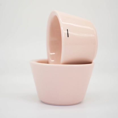 Two Pink Ni Wares Espresso Toto cups stacked on top of each other with one small '-' dash line symbolising the thin sided lip on a white background Basic Barista Cafe Equipment Espresso Coffee Cups
