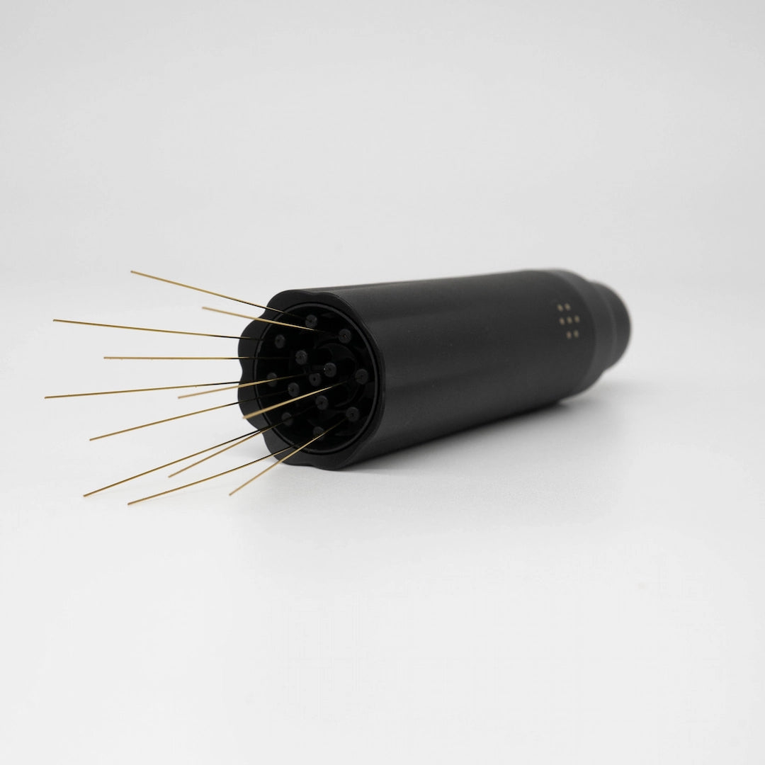 Nucleus Bloom Black cylindrical device with gold needle prongs on a white background