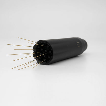 Nucleus Bloom Black cylindrical device with gold needle prongs on a white background