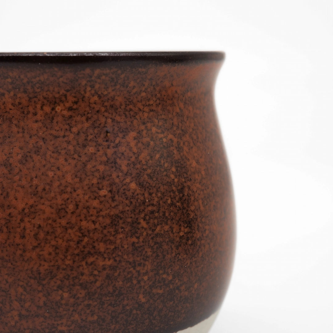 Close-up of a Red ceramic origami pinot cup on a white background