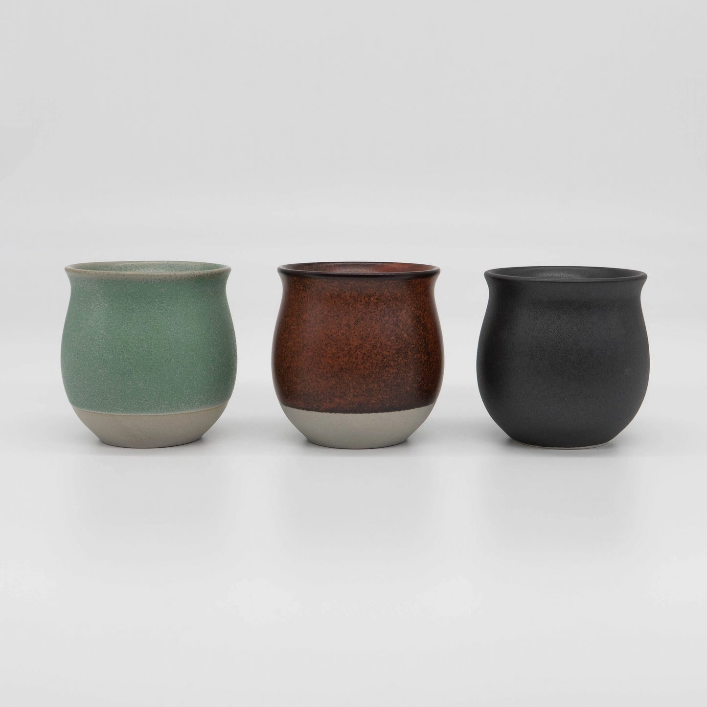 Three Origami Pinot ceramic cups in green, red, and black on a white background - Basic Barista coffee gear coffee cups