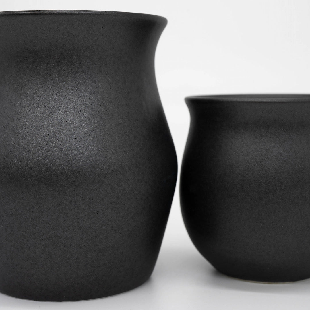 Two Origami Coffee Cup Matte Black Specialty Coffee Cups close up textured ceramic Basic Barista Brew Gear on white background