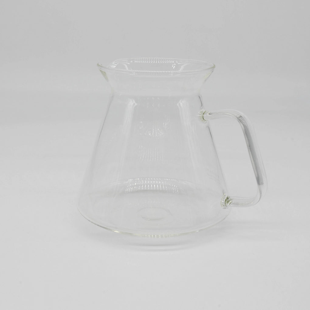 Clear glass HARIO x Origami Dripper coffee carafe on a white background