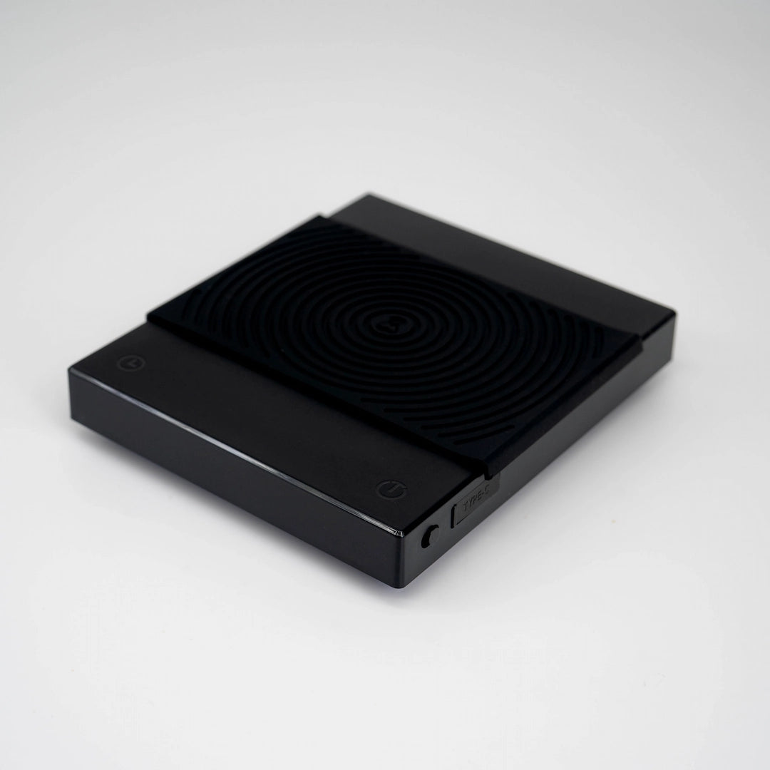 Timemore Black Mirror Basic 2 Coffee Brewing Scale, black colour, displaying digital screen with weight measurements. Basic Barista Coffee Brewing Scale Budget Coffee Gear Scale Brewers