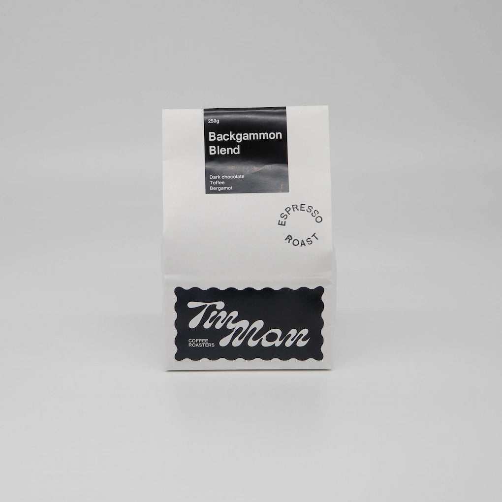 Coffee package labeled 'Backgammon Blend' by Tin Man Coffee Roasters on a gray background Backgammon Blend Roasted Coffee Beans Basic Barista