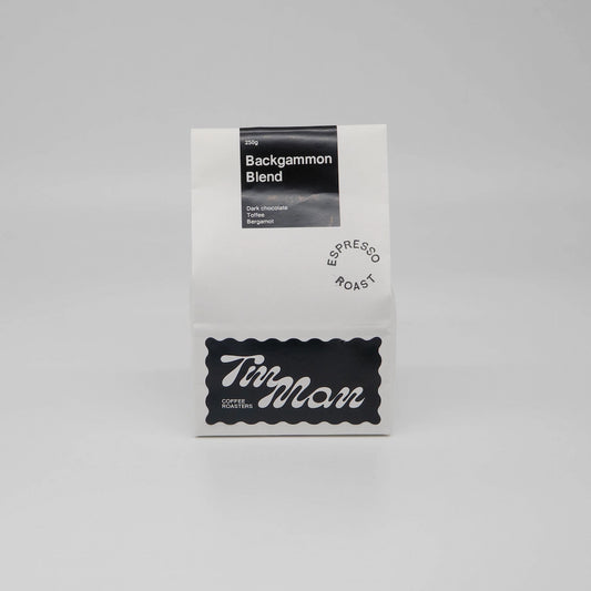 Coffee package labeled 'Backgammon Blend' by Tin Man Coffee Roasters on a gray background Backgammon Blend Roasted Coffee Beans Basic Barista