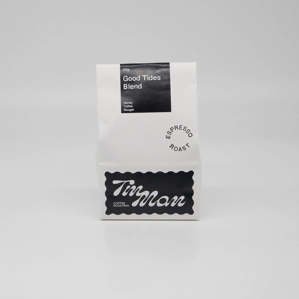 Coffee package labeled 'Good Tides Blend' by 'Tin Man' on a grey background Roasted Coffee Beans Basic Barista