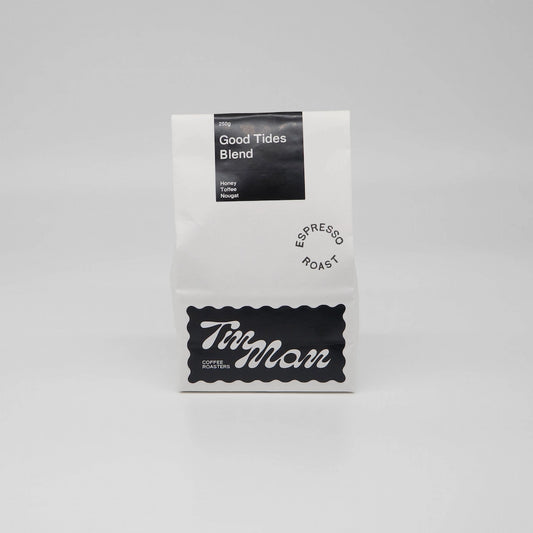 Coffee package labeled 'Good Tides Blend' by 'Tin Man' on a grey background Roasted Coffee Beans Basic Barista