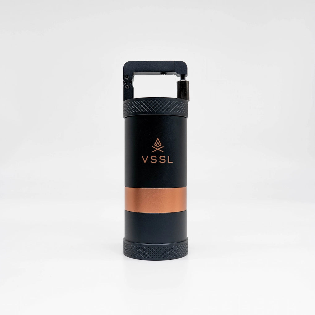 Black and copper-colored travel coffee grinder with VSSL logo on a white background | VSSL Java Grinder Basic Barista Portable coffee Grinders