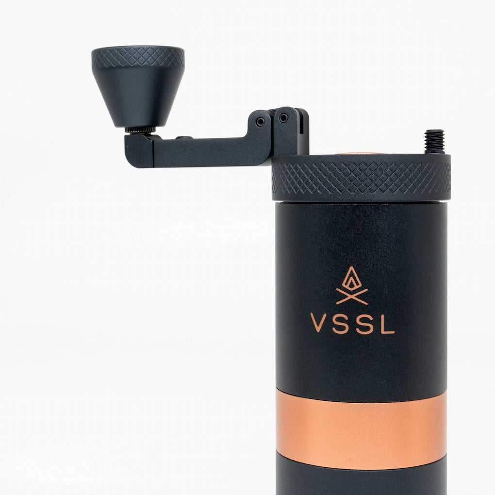 Black and rose gold Java VSSL Coffee Grinder handle and crank folded out on a white background | VSSL Java Grinder Basic Barista Portable coffee Grinders
