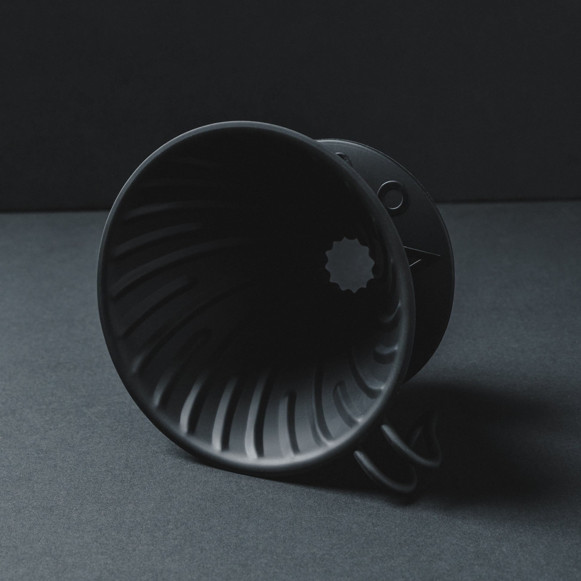 Hario V60 Metal Matte Black Coffee Dripper on side - Close up shadowy shot with cinematic pour over aesthetic Basic Barista Photography